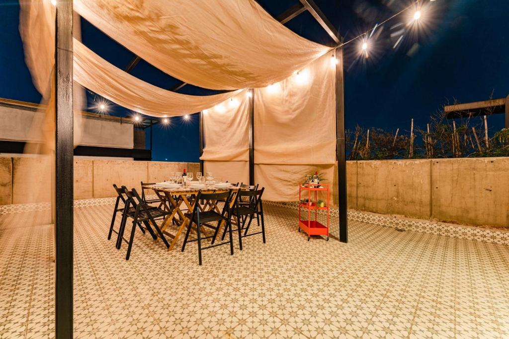 a table and chairs under a tent with lights at Trendy La Roma Condo with Parking & Patio in Mexico City