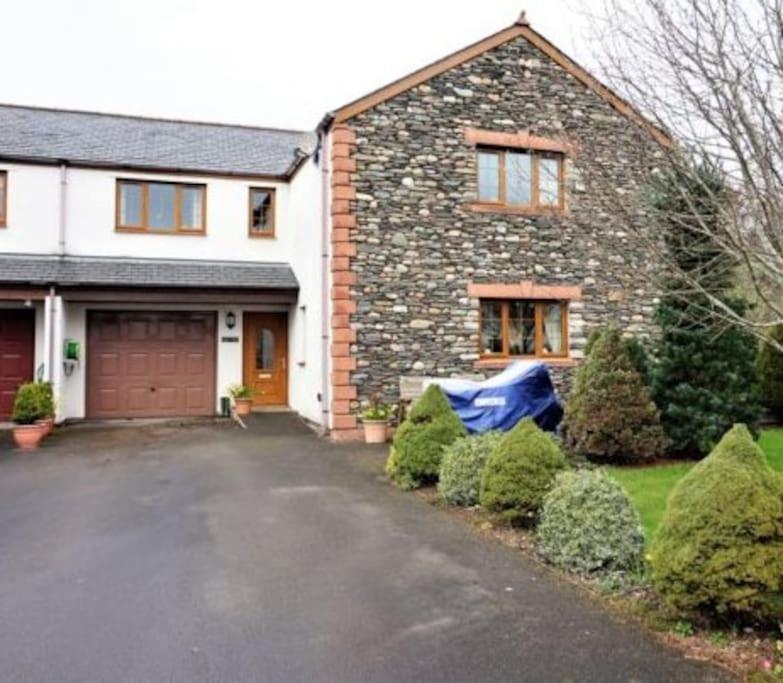 a brick house with a garage and a driveway at Large modern house in small rural Hamlet. in Duddon