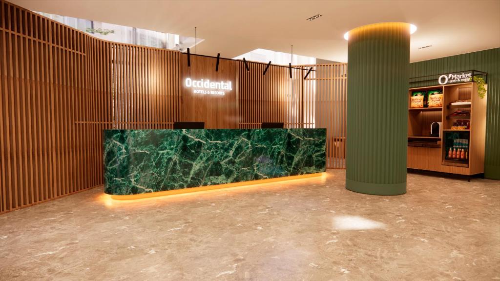 a lobby with a green marble counter in a building at Occidental Pamplona in Pamplona