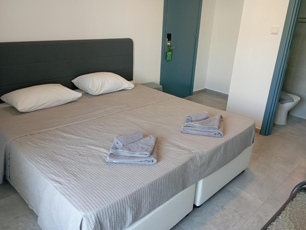 a bedroom with a bed with towels on it at BlueSuite in Ayia Napa