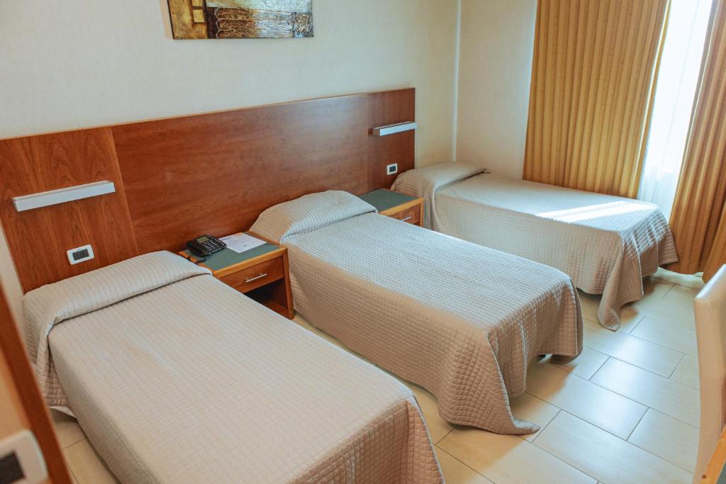 Postel nebo postele na pokoji v ubytování Hotel Amico