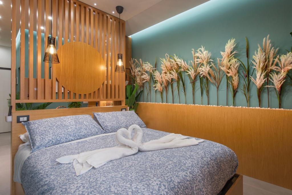 a bedroom with a bed with a towel on it at Napoli Suite Station in Naples