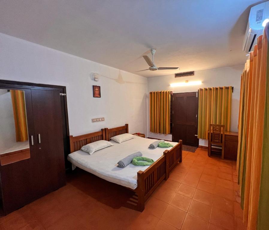 a bedroom with a bed in a room at Bodhi Beach House Kannur in Kannur