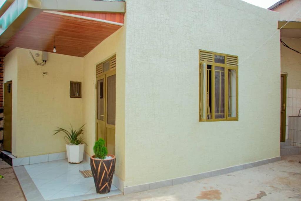 a house with a door and a plant in front of it at Kigali bright housse in Kigali