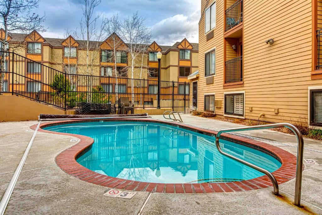 a swimming pool in front of a building at Carriage House #215 in Park City