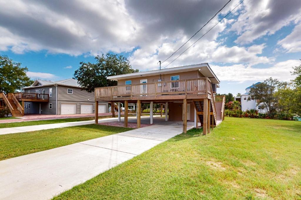 a large house with a deck on a lawn at Lazy River, Lazy Days in Shoreline Park
