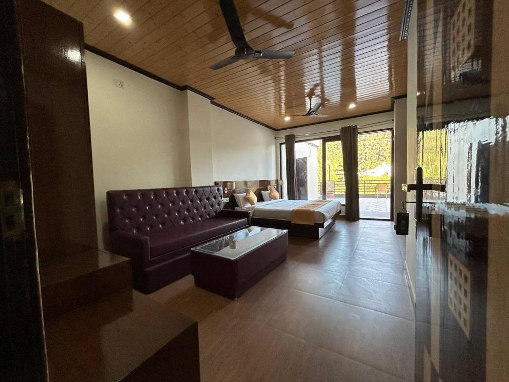 a large living room with a couch and a table at Hotel 7 Heavens in Mussoorie