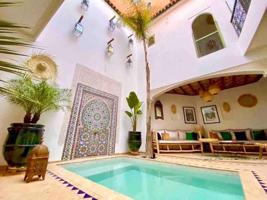 a house with a swimming pool in a room with a patio at Riad ABADA Medina Marrakech (Sidi Mimoun) in Marrakech