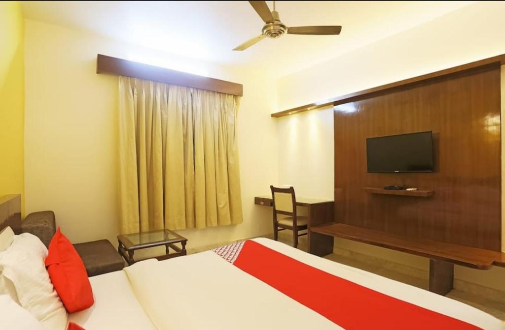 a hotel room with a bed and a flat screen tv at Abhi Residency Hotel in New Delhi