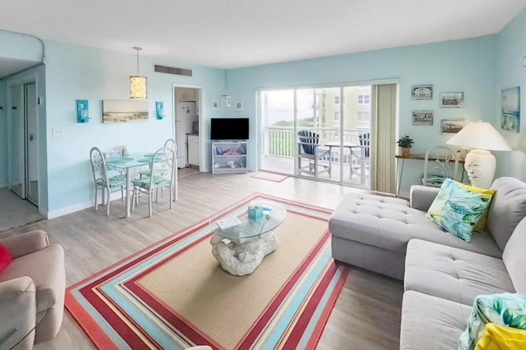 a living room with a couch and a table at Turtle Time Suite in Satellite Beach