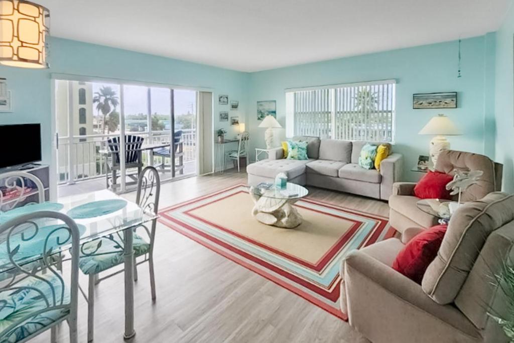 a living room with a couch and a table at Turtle Time Suite in Satellite Beach