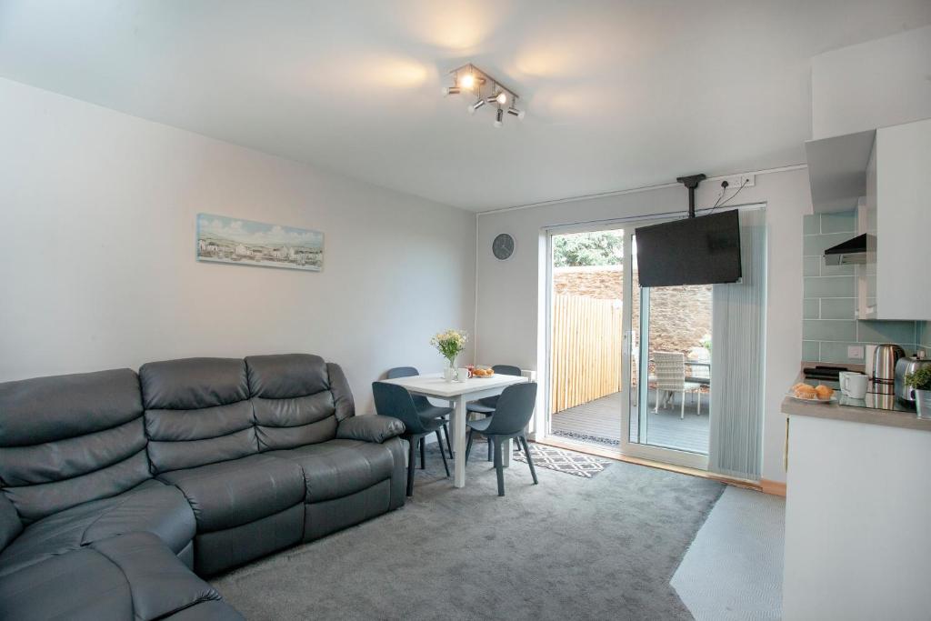 a living room with a couch and a table at Garden Apartment - Uk44654 in Paignton