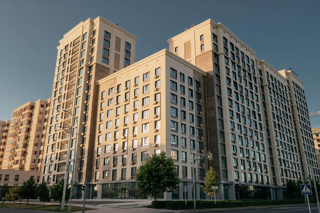 a large building with two tall buildings at Элитная квартира возле площади in Shymkent