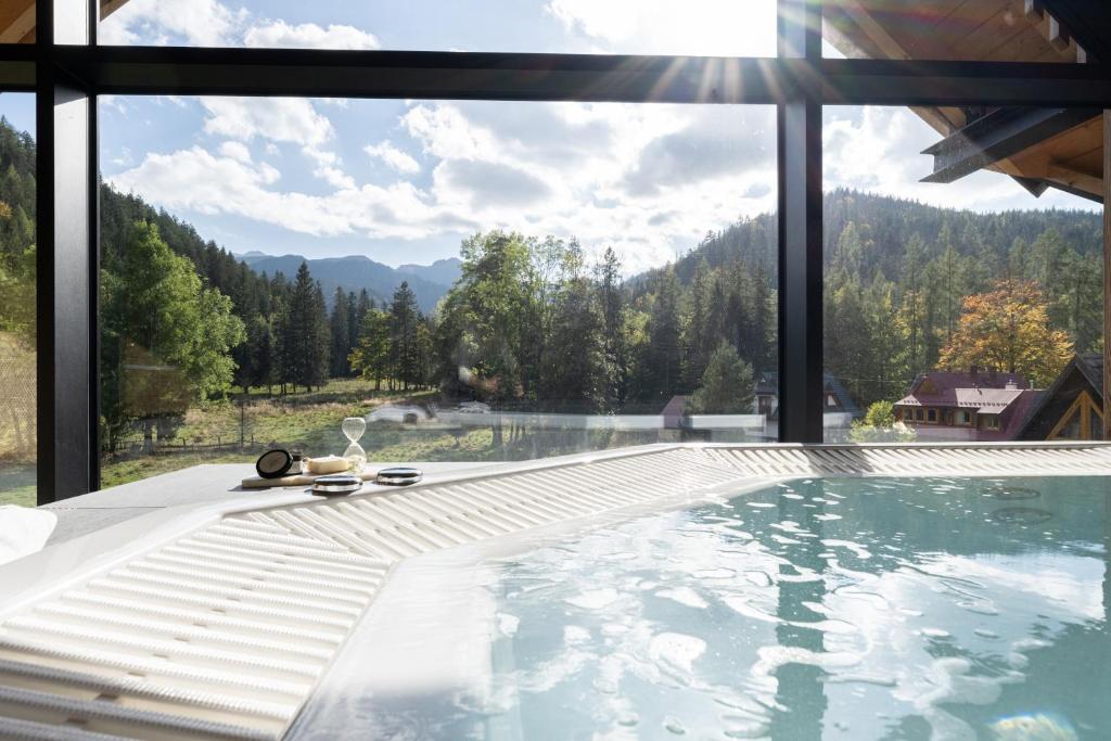 a swimming pool with a view of the mountains at Rezydencja OWCA NA SZLAKU in Zakopane