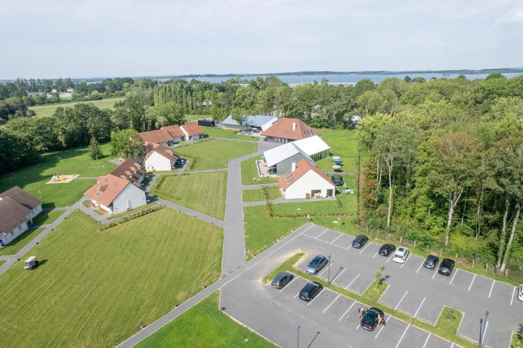 an aerial view of a house with a parking lot at Hôtel Lac d'Orient in Mesnil-Saint-Père