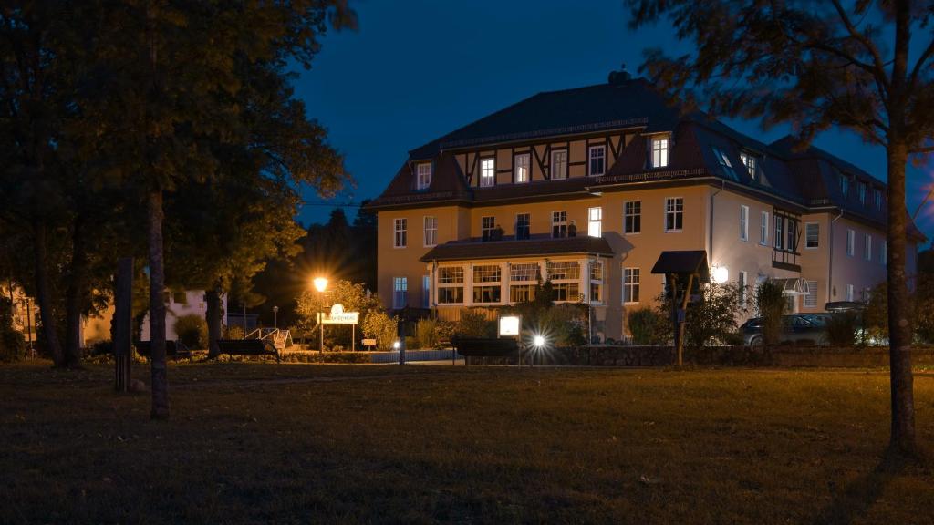 a large house at night with its lights on at Haus Brandenburg in Stechlin