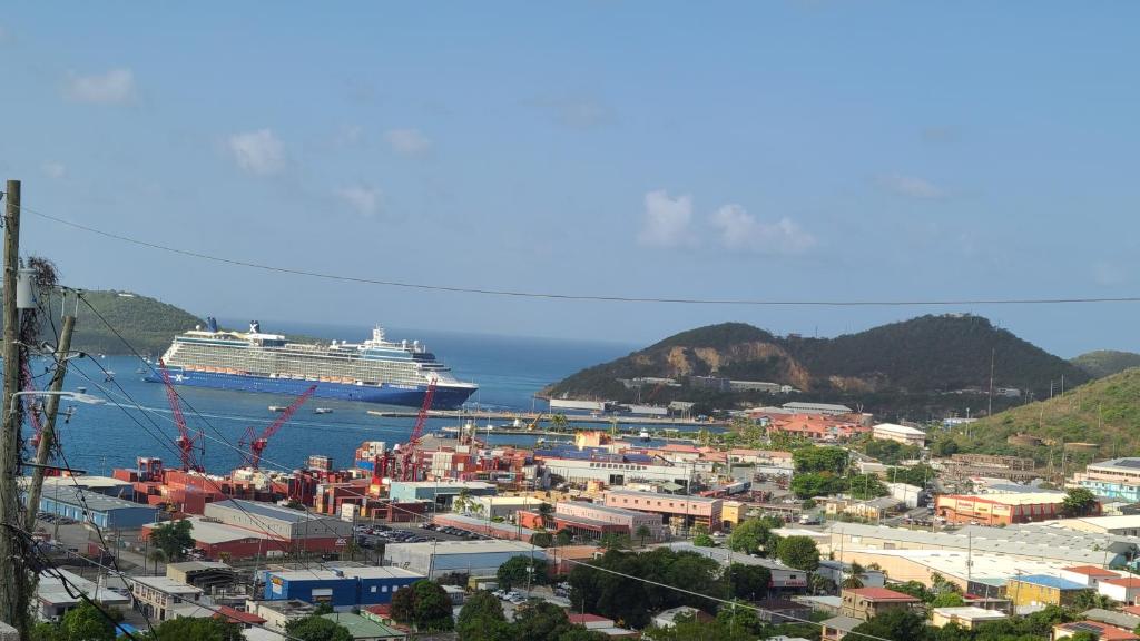 a cruise ship is docked in the ocean with a city at Home Away! in Frenchtown