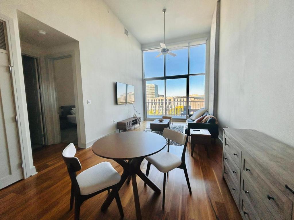 a living room with a table and chairs and a large window at Downtown Oasis Heart Of Austin in Austin