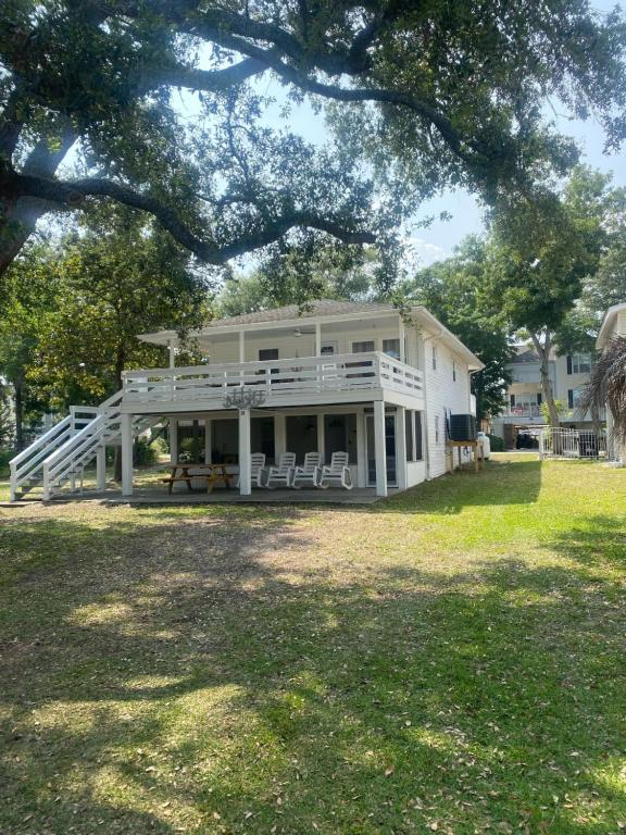 a large white house with a porch and chairs at ON Deck few Blocks Fr BEACH 6 BR/4Ba Newly Reno in Myrtle Beach