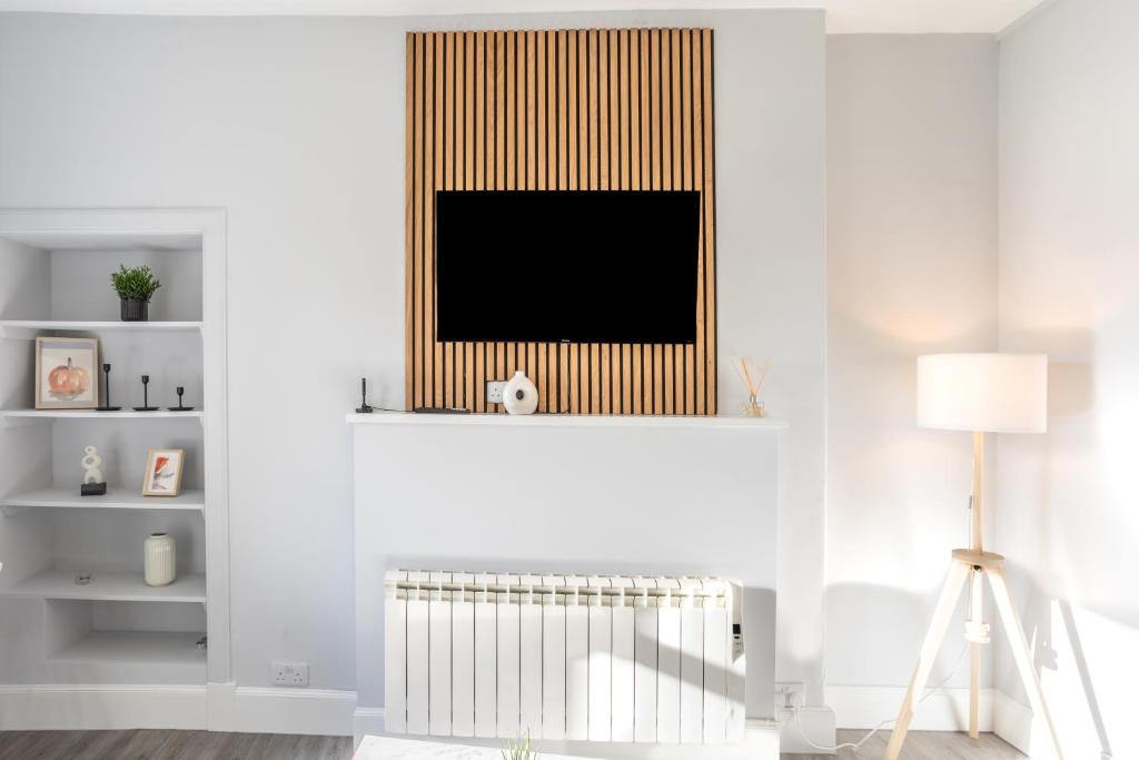 a living room with a radiator and a television at Beautiful Ground Floor Apartment in Perth