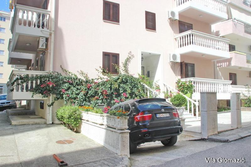 a black car parked in front of a building at Apartment Glomazic in Budva