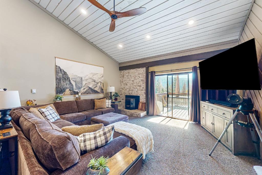 a living room with a couch and a flat screen tv at Huntington Lake Condo #102 in Lakeshore