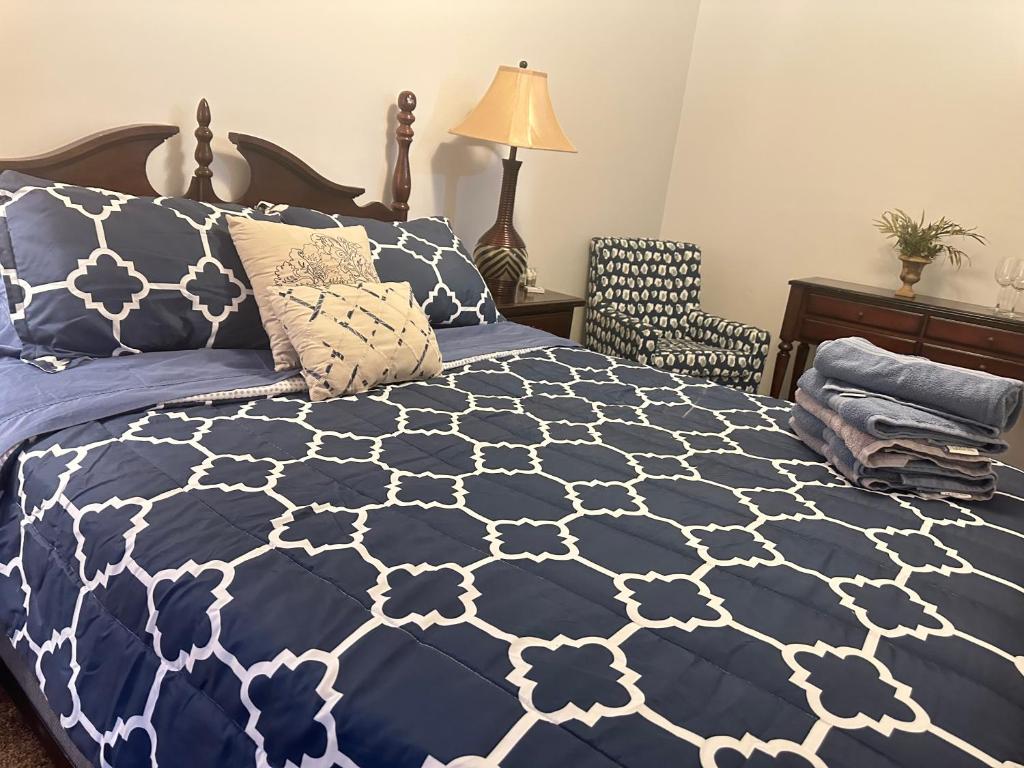 a bedroom with a blue and white comforter on a bed at The Trenton Gallery in Trenton