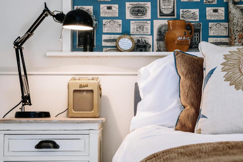 a bedroom with a bed and a desk with a lamp at Lisnacurran in Hillsborough