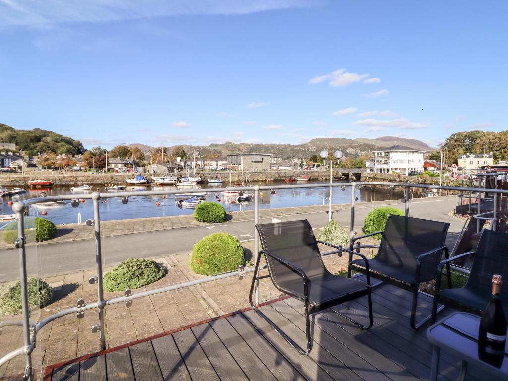 a balcony with chairs and a view of a river at Sea Breeze in Porthmadog