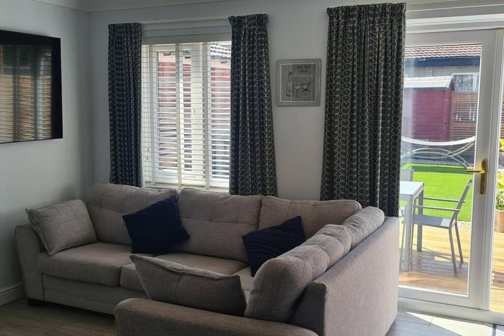 a living room with a couch and a window at Runway Airbnb in Manchester