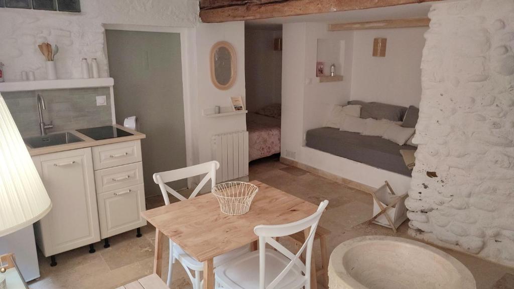 une cuisine et une salle à manger avec une table et une chambre dans l'établissement Studio climatisé au calme au coeur du village médiéval avec rue piétonne, à Cagnes-sur-Mer