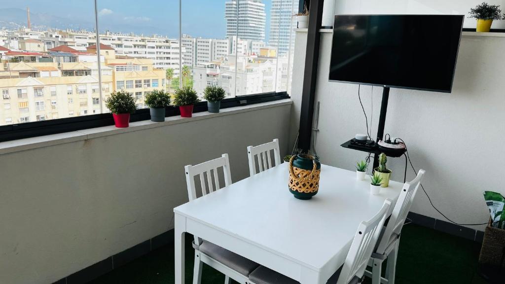 A television and/or entertainment centre at Ático con Piscina y Vistas al Mar Habitat Litoral