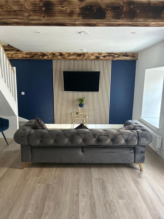 a living room with a couch and a blue wall at A Village Gem in Mullingar