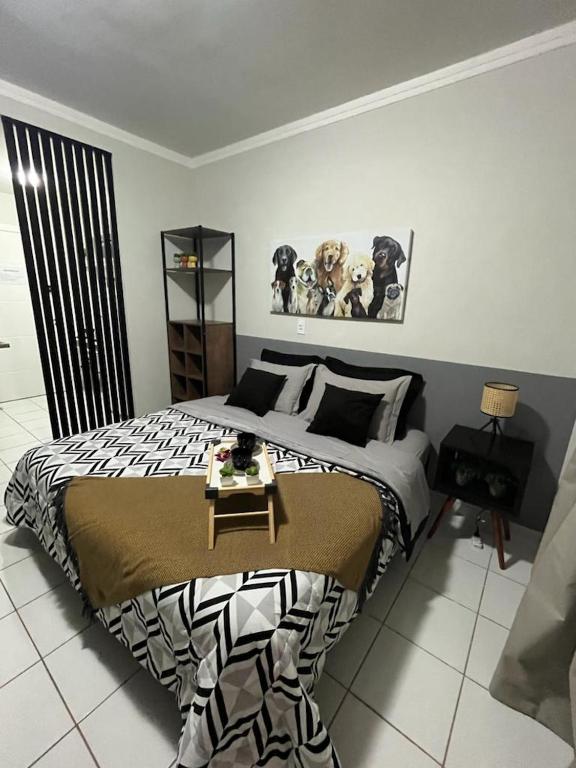 a bedroom with a large bed with a table on it at Travellar Spot 313B in Ribeirão Preto