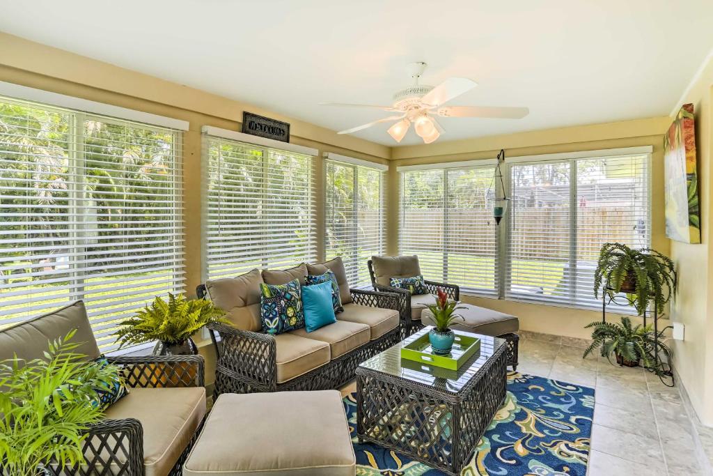 a screened in porch with a couch and chairs at Fort Myers Bungalow - 12 Miles to the Beach! in Fort Myers