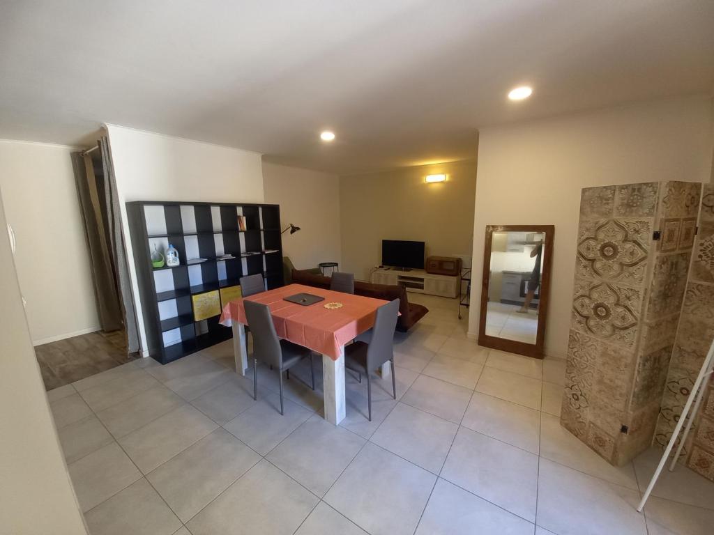 een kamer met een tafel en stoelen en een woonkamer bij Console Camprini Rooms & Apartments in Faenza