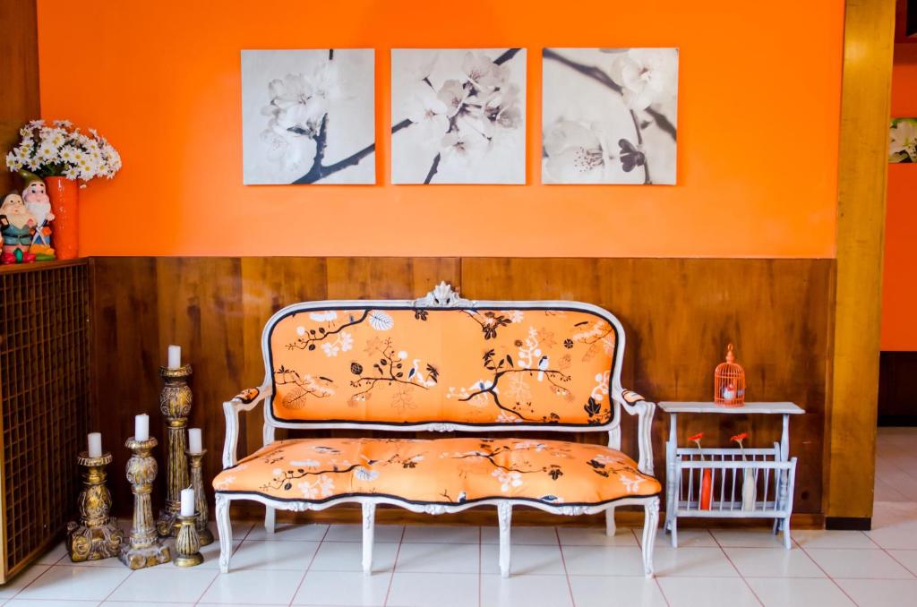 an orange chair in a room with an orange wall at Albergo Villa Gaia in Chianciano Terme