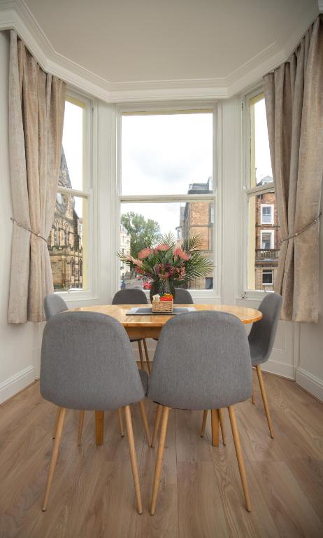 a dining room with a wooden table and chairs at Sunny View in Scarborough