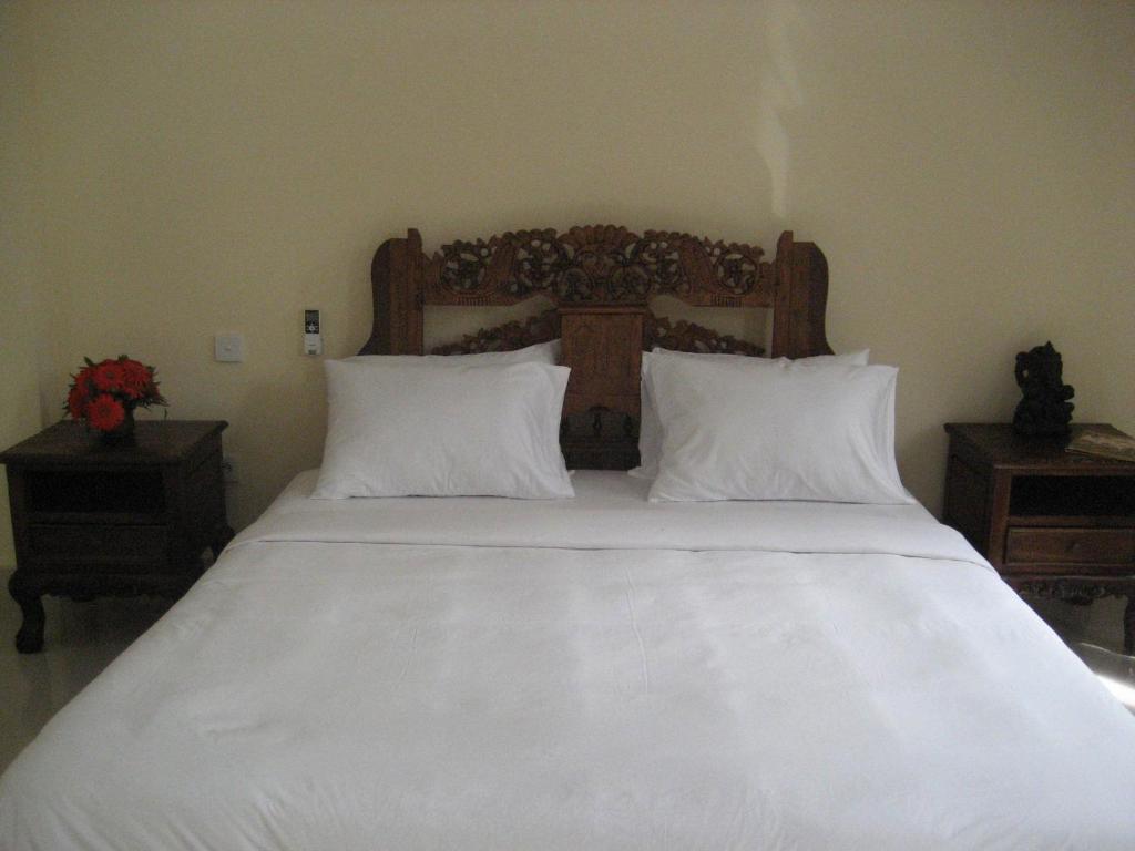 Postel nebo postele na pokoji v ubytování Ubud Wins Bungalow