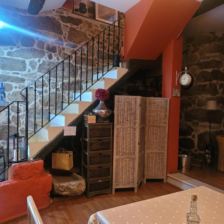 eine Treppe in einem Zimmer mit einer Steinmauer in der Unterkunft El Abuelo Angel in Ribadavia