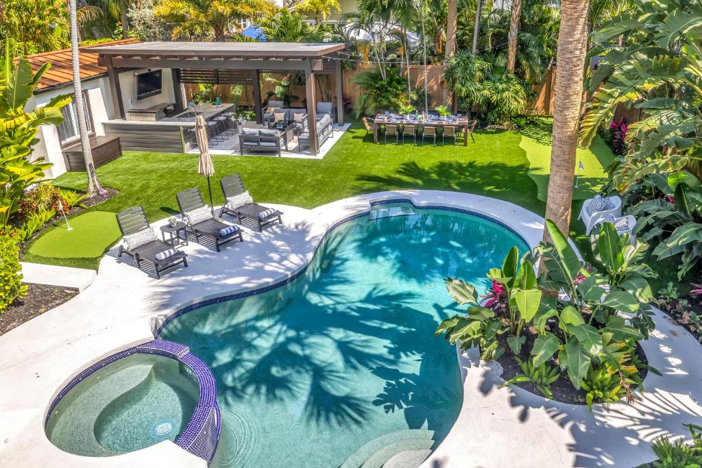 a swimming pool in the backyard of a house at Special Pricing, Las Olas Retreat, Heated Pool, Golf and Family-Ready in Fort Lauderdale
