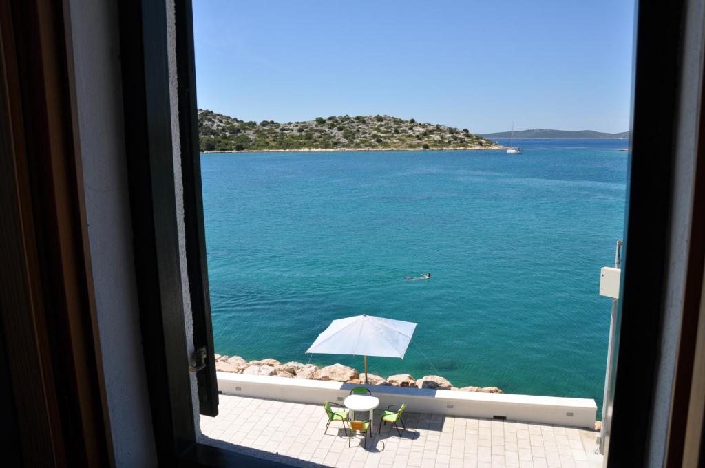 a view of the ocean from a window at Apartment Ružica in Tribunj