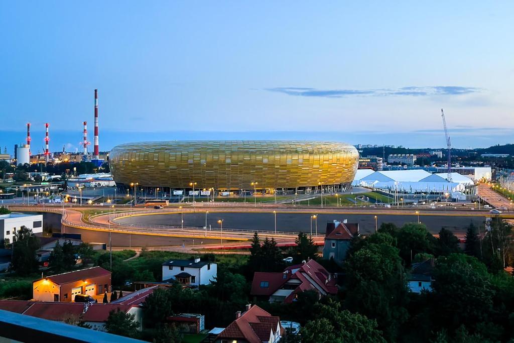 a view of a large building in a city at Sea & Stadium plaża Brzeżno in Gdańsk