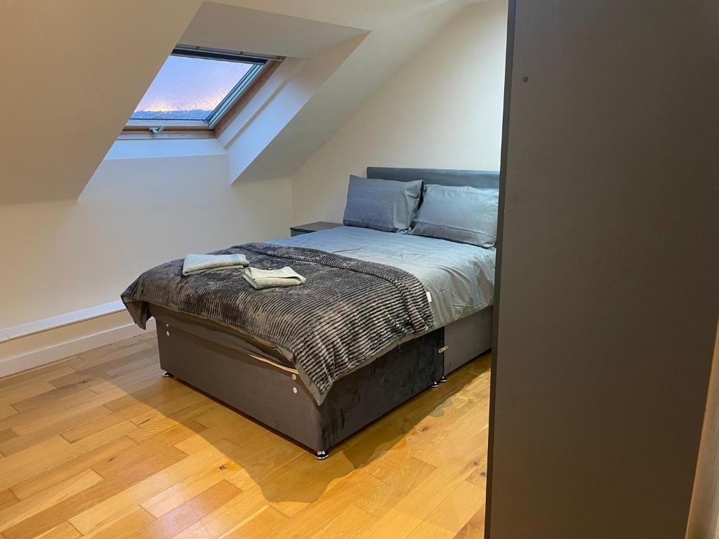 a bedroom with a bed in a attic at Mayfair- Charming 2BR family Apartment in Greetland