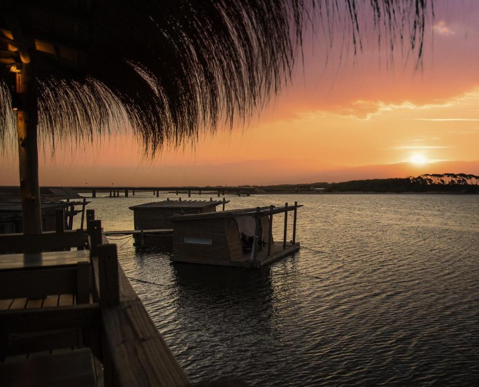 a boat is docked on the water at sunset at Laguna Garzón Lodge in José Ignacio