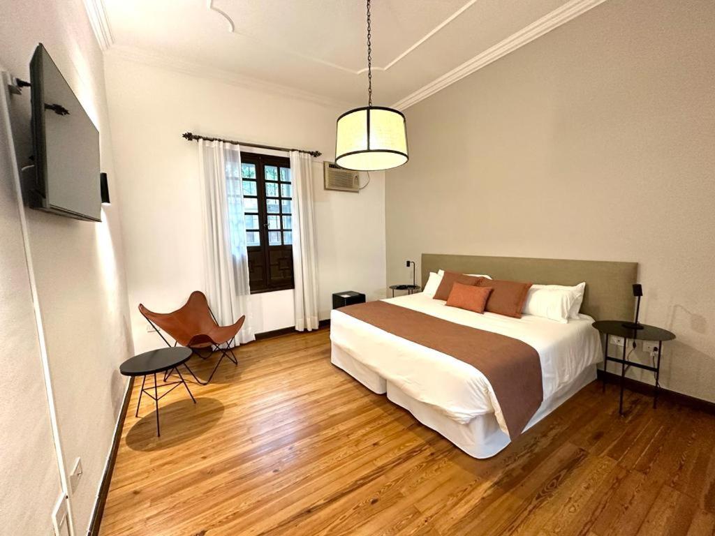 a bedroom with a bed and a television in it at Hotel Del Virrey in Salta