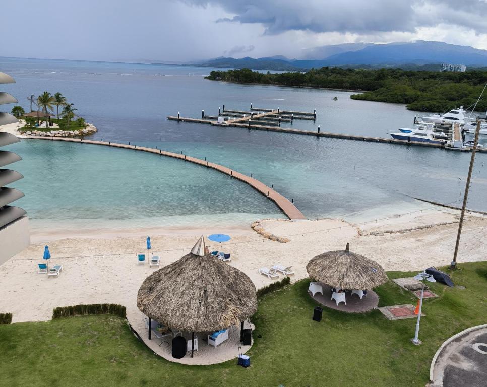 an aerial view of a beach with a pier and water at Playa Escondida: Confort y relax en el Caribe in María Grande