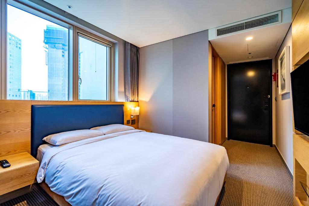 Postel nebo postele na pokoji v ubytování Centum Business Hotel