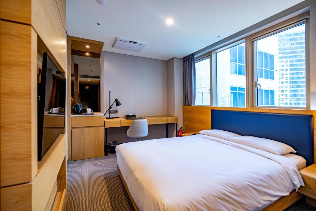 Postel nebo postele na pokoji v ubytování Centum Business Hotel