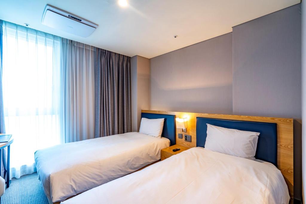 Postel nebo postele na pokoji v ubytování Centum Business Hotel